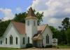 White church with a brown roof.